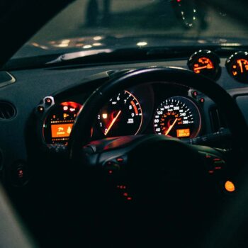 Orange lights on car speedometer and dashboard at night