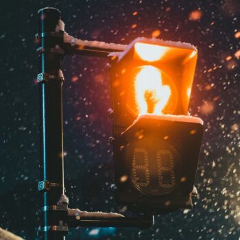 Red hand crosswalk light in a snowy night